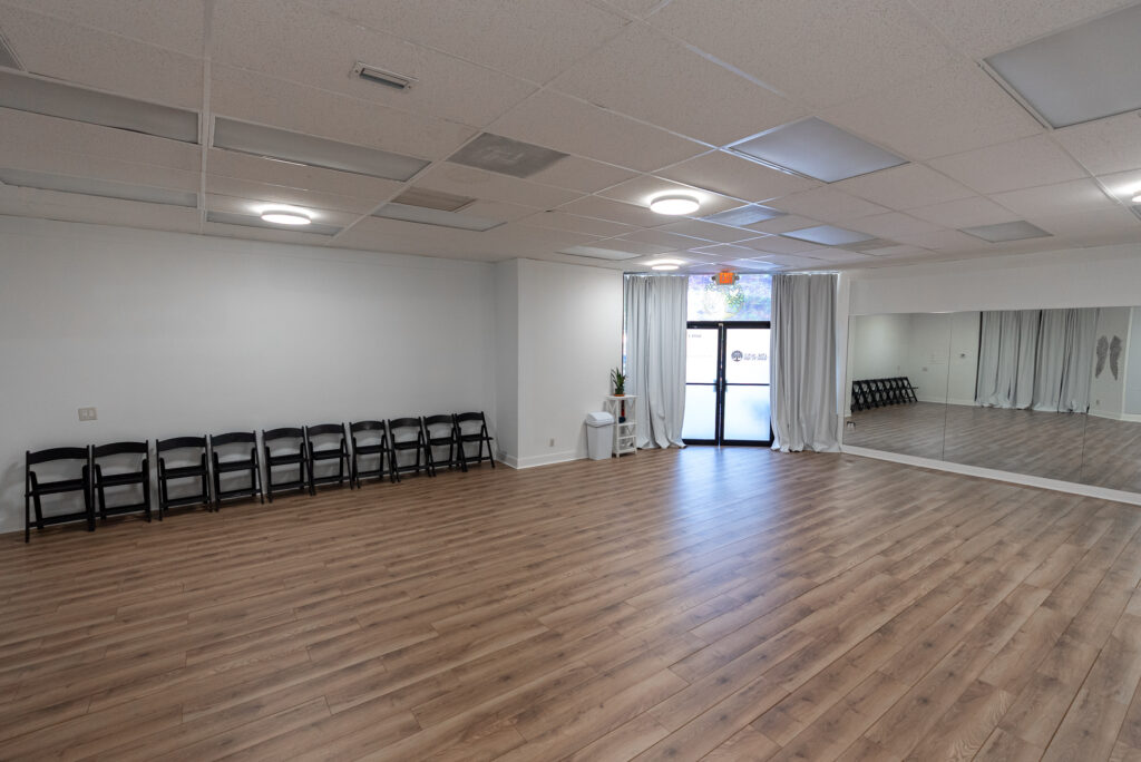 Studio space set up with chairs for a community gathering